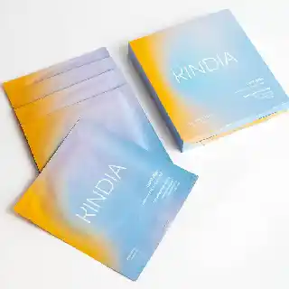 KINDIA Aura Drip face mask for glowing skin in blue and yellow gradient packaging with multiple sheet masks for hydration, brightening, and dewy radiant skin