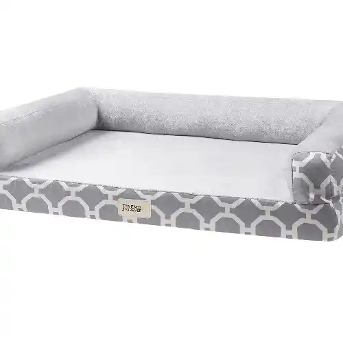 A sofa-style orthopedic dog bed with a supportive foam base and soft raised bolsters on all sides, creating a cozy space where a dog can rest its head and body comfortably for better support and relaxation.